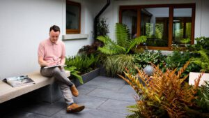 Philip Laffan interior designer reviewing furniture catalogues for a client project in Ireland